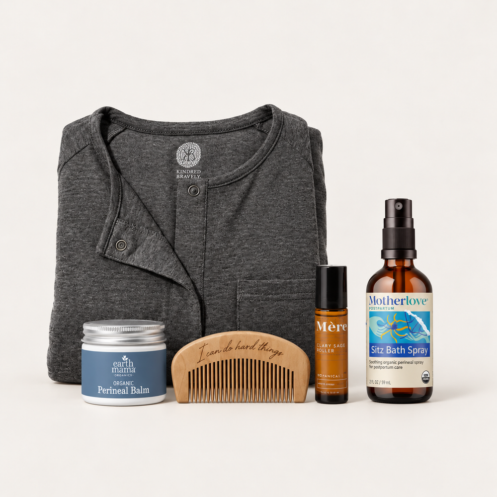 The Birth Set with charcoal labor gown, perineal balm, wooden labor comb, clary sage roller and sitz bath spray.