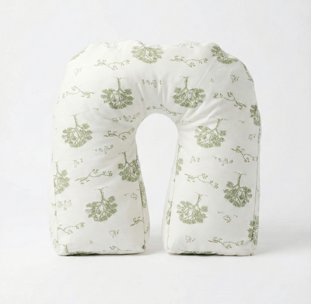 The Tush Present U-shaped support pillow in a pale green floral print.